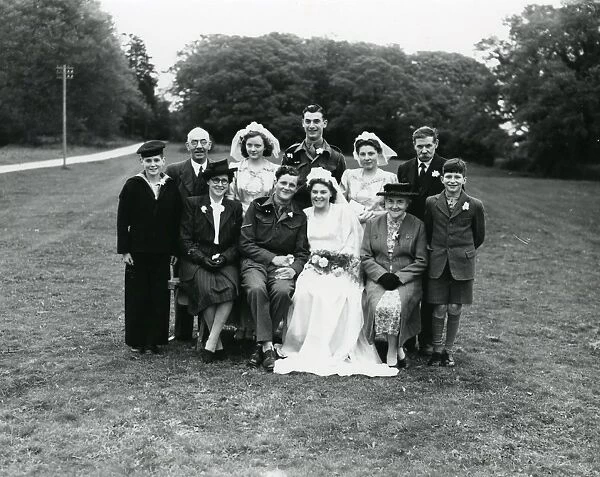 Family group with bride and groom at a wedding in Ebernoe, 1940s