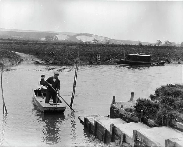 Ferry at Bury, 1931. Ferryman and his wife crossing the river Arun Photograph