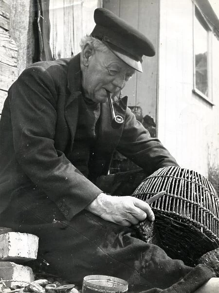Fisherman mending a prawn pot, 1960s