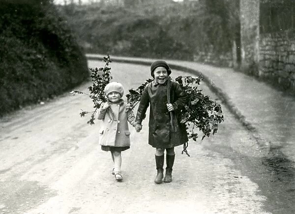 Two girls taking home some holly, 1932