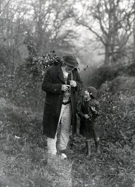 Grandfather and child gathering holly, December 1932