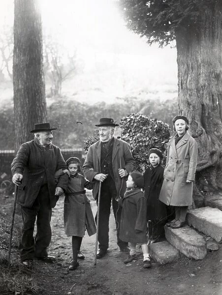 Group of people chatting on a footpath in woods at Upperton, Sussex, December 1935