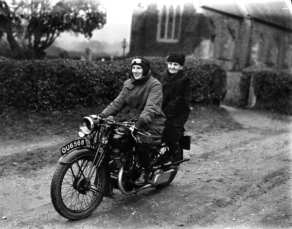 Two ladies riding a motorbike