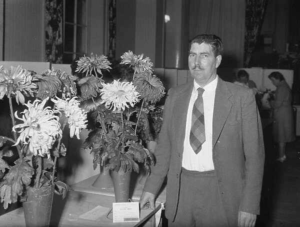 Man with flower exhibit at show, 2 November 1961
