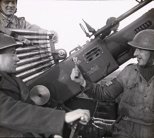Two men on a gun at Canadian anti-aircraft battery, Felpham, December 1942