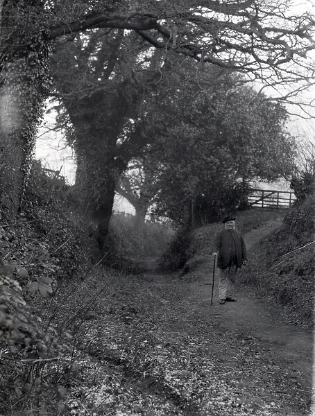 Old man walking in country lane at Dean, Sussex, January 1935