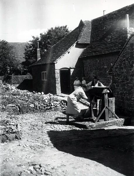 Two people using a well on a farm at Upperton, Sussex, August 1936