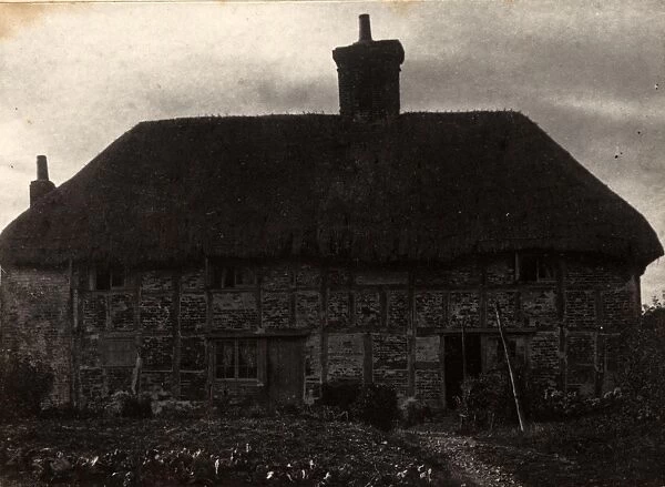 Racton, 1908. A cottage with thatched roof, garden in front
