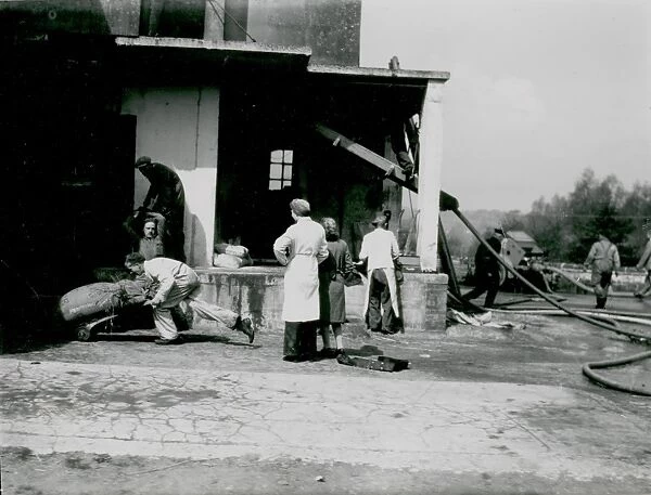 Rescuing items from a fire at Coultershaw Mill, Petworth, 16 May 1946