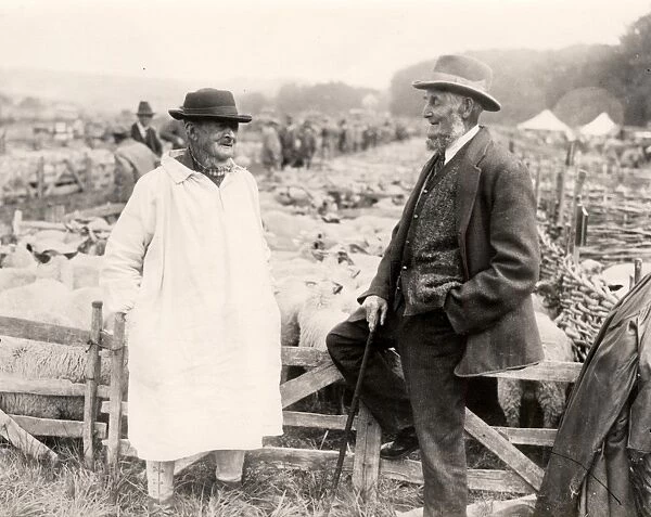 Two shepherds sitting on a fence at Findon Sheep Fair, 1931