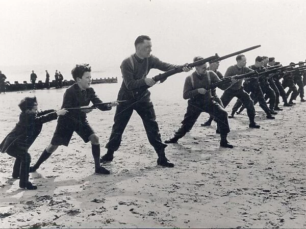 Soldiers training with rifles and bayonets on the beach [1940]