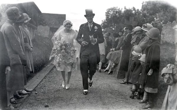Wedding, June 1927. Wedding couple walking down the churchyard path, flanked by on lookers