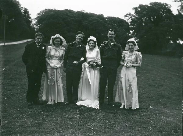 Wedding party posing in church grounds at Ebernoe, Sussex, 1940s