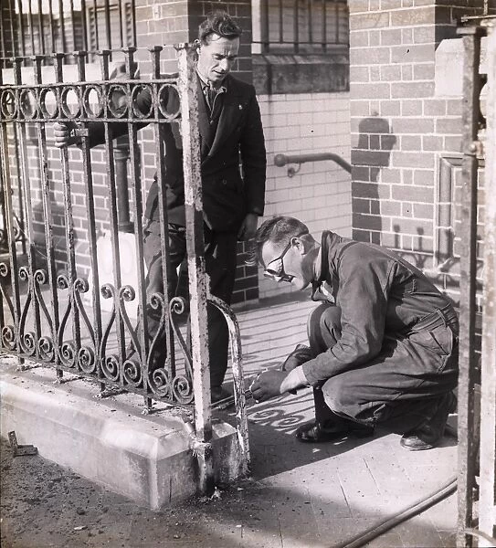 Workmen removing iron railings [1939-1945]