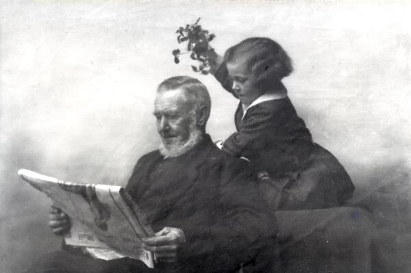 Young girl holding mistletoe over elderly man