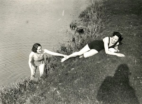 Young ladies posing on a river bank in Stopham, March 1938