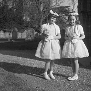 2 young bridesmaids outside church
