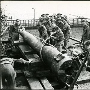 Bognor Regis: men of Royal Artillery moving barrel of gun