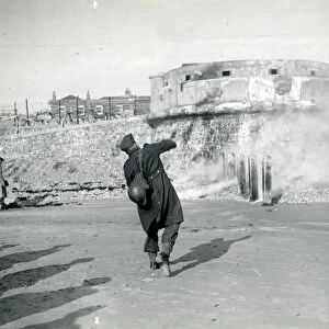 Bognor Regis: soldier throwing gas canister on the beach 1939-1945