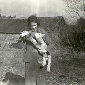 Bottle feeding a lamb at Strood Farm - March 1940