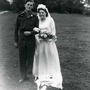 Bride and Groom posing in church grounds, 1940s