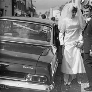 Bride and Groom on Wedding Day standing next to Wedding car
