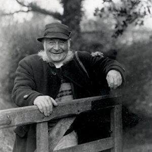 Country gentleman standing behind gate, Upperton, West Sussex
