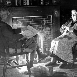 Elderly couple by their fireside