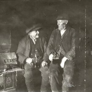 Two elderly gentleman having a drink in an inn at Lurgashall, February 1934