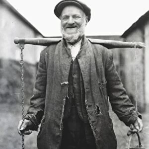 Farm worker with buckets on a yoke, Lavant, Sussex
