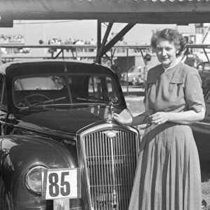 Lady and vintage car at Goodwood motor circuit