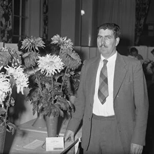 Man with flower exhibit at show, 2 November 1961