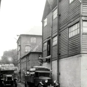 Print of a van being loaded at a warehouse, taken in 1935 Print of a van being loaded at a warehouse, taken in 1935