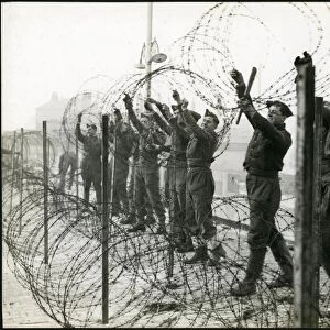 Soldiers putting up barbed wire entanglements on the seafront, Bognor Regis 1940