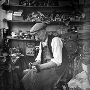 The village shoemaker at work in his shop, 1920s