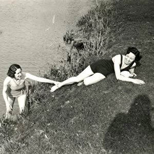 Young ladies posing on a river bank in Stopham, March 1938