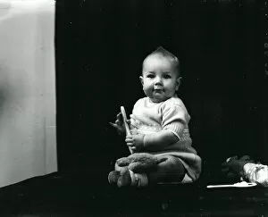 Images Dated 14th August 2013: 1940s portrait of a baby posing with toys