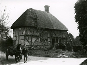 Farmer Prints: Bignor General Shop with thatcher at work, February 1938