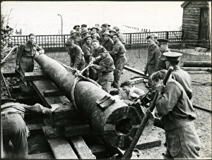 Bognor Regis: men of Royal Artillery moving barrel of gun