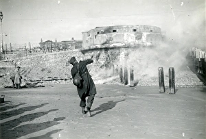 Uniform Prints: Bognor Regis: soldier throwing gas canister on the beach 1939-1945