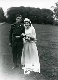 Images Dated 14th August 2013: Bride and Groom posing in church grounds, 1940s