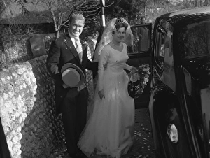 Bride and Groom posing by limousine