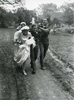Bride and Groom being showered by confetti, 1940s Bride and Groom being showered by confetti, 1940s