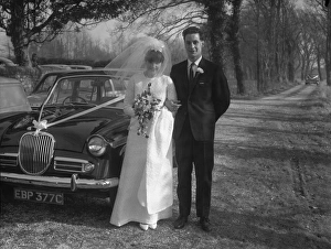 Marriage Prints: Bride and Groom standing by wedding car