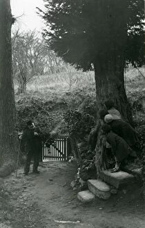 Images Dated 25th July 2013: Children hiding from elderly man whilst gathering holly, December 1935