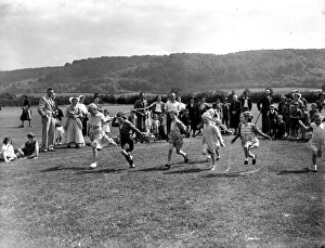 Childrens skipping race with onlookers, June 1953