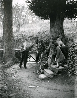 Country man lighting his pipe at Upperton, December 1935
