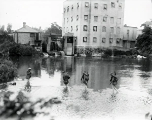 Two East Yorks soldiers and two officers wading through mill pond near Petworth Two East Yorks soldiers and two officers wading through mill pond near Petworth