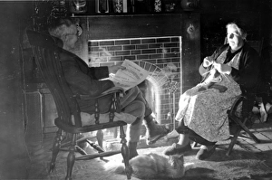 Elderly couple by their fireside