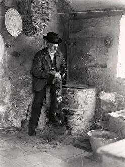 Images Dated 6th June 2012: Elderly gentleman polishing horse brasses, September 1935
